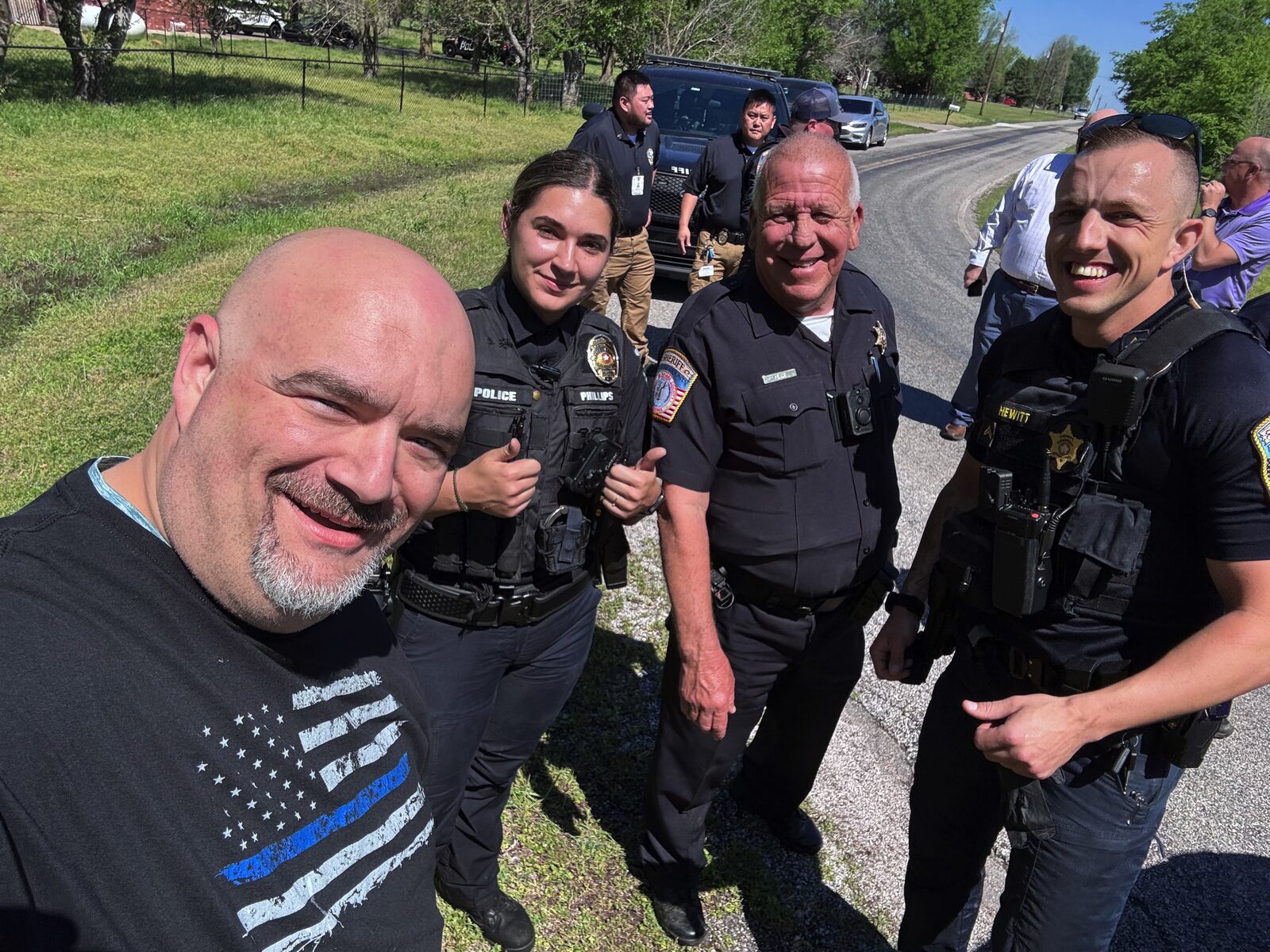 Chief Eaton in a Thin Blue Line shirt selfie with Officers Phillips and Hewitt and another officer — assisted in the apprehension of an escaped inmate