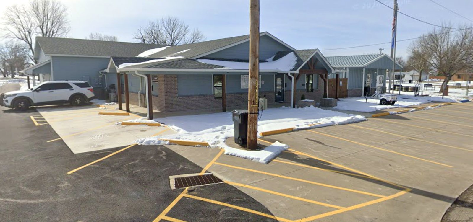 Talala Town Hall after expansion, blue-grey siding and timber entry, winter day